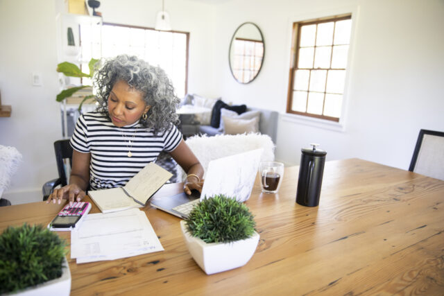 Mature Black Woman Working at Home on laptop